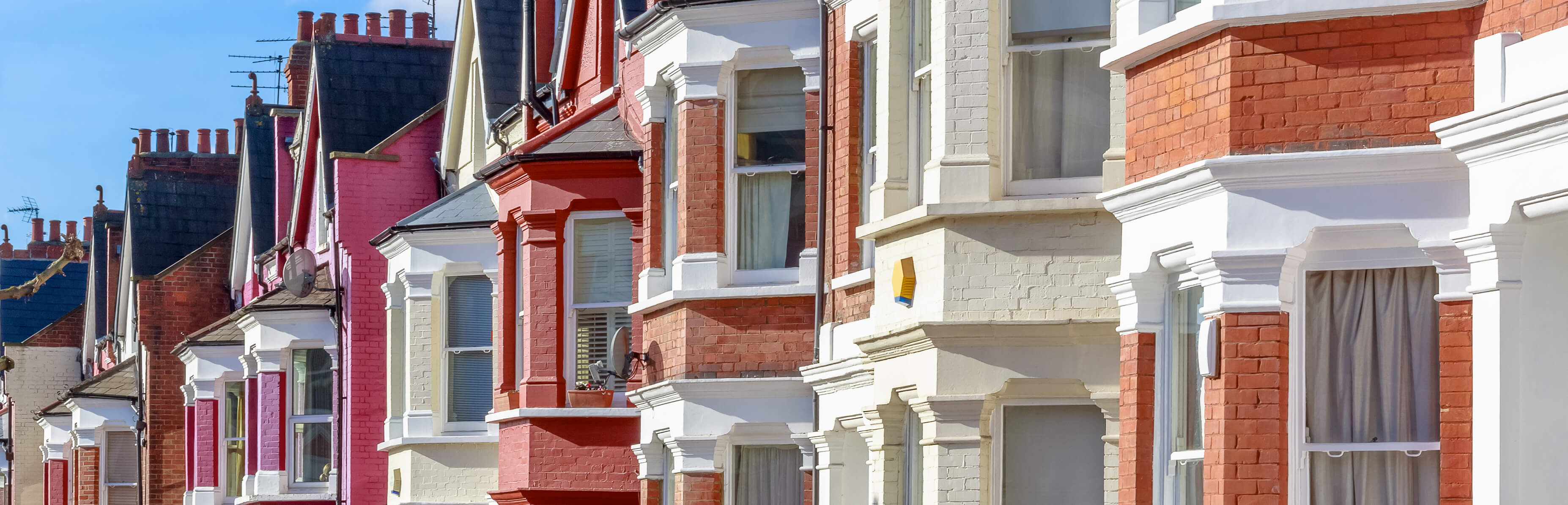 domestic residence planning advice image of brightly coloured houses side by side